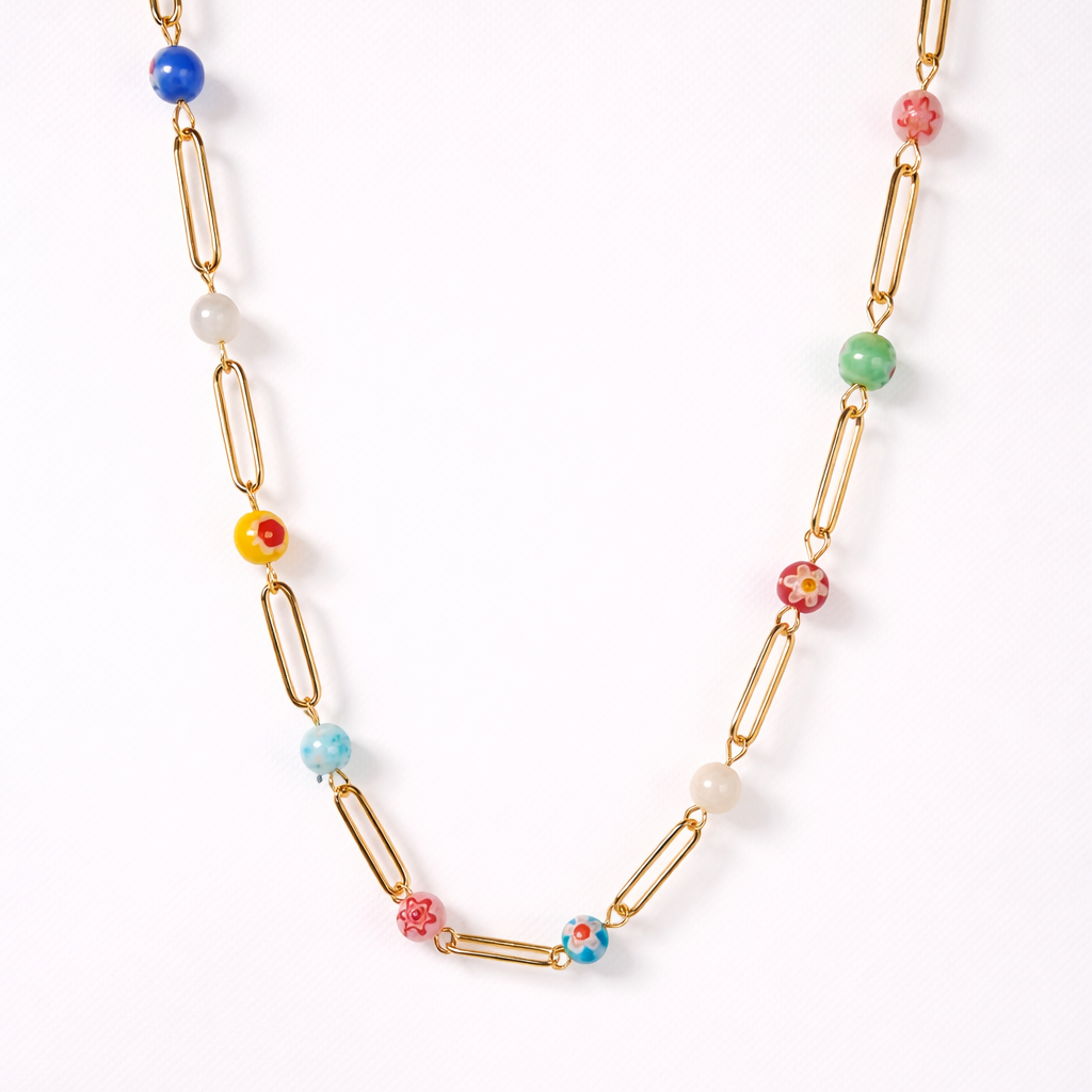 Necklace with colorful beads and gold paperclip links on a white background