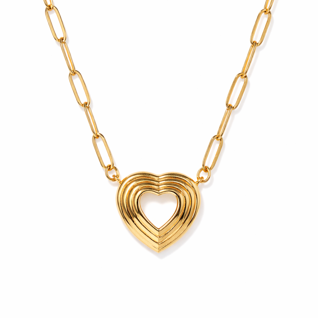 Gold heart-shaped pendant necklace on a white background